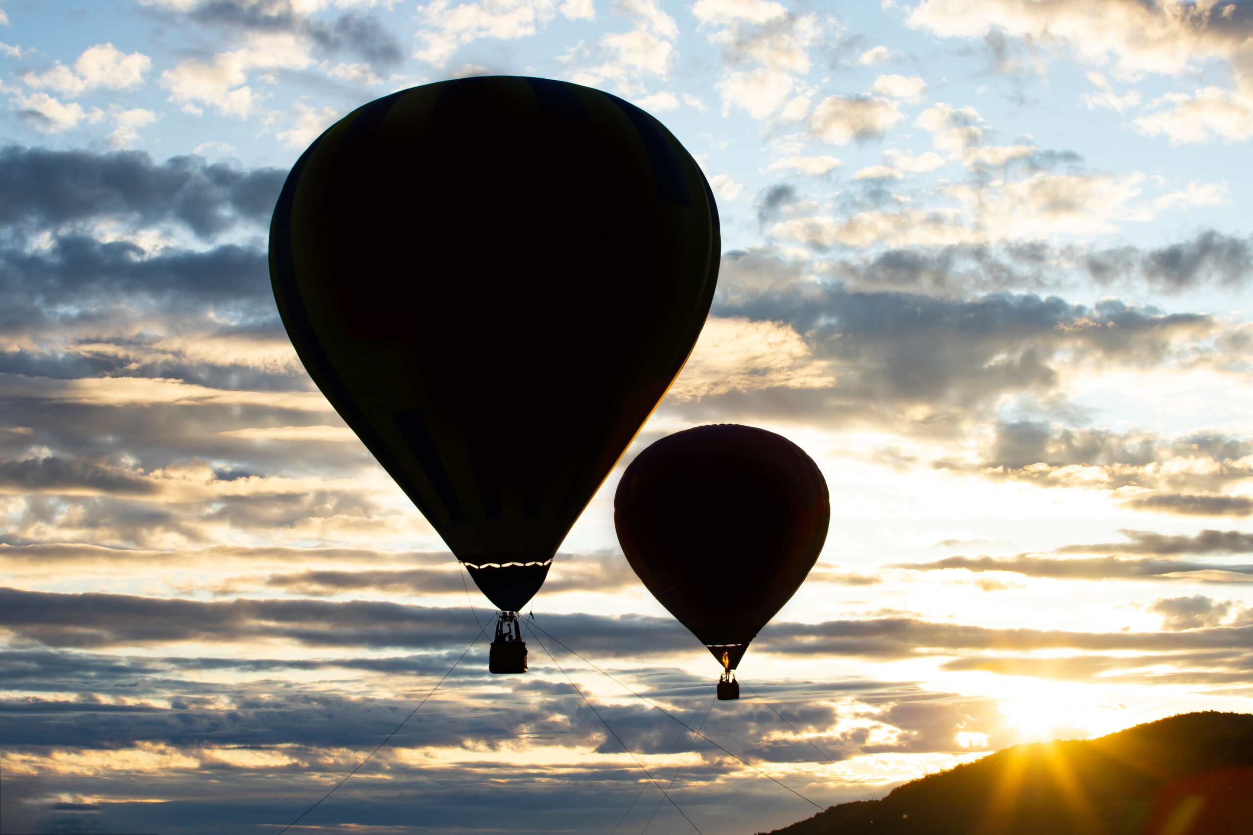 Silhouette of a hot air balloon flying in the sunset. Travel, freedom concept.